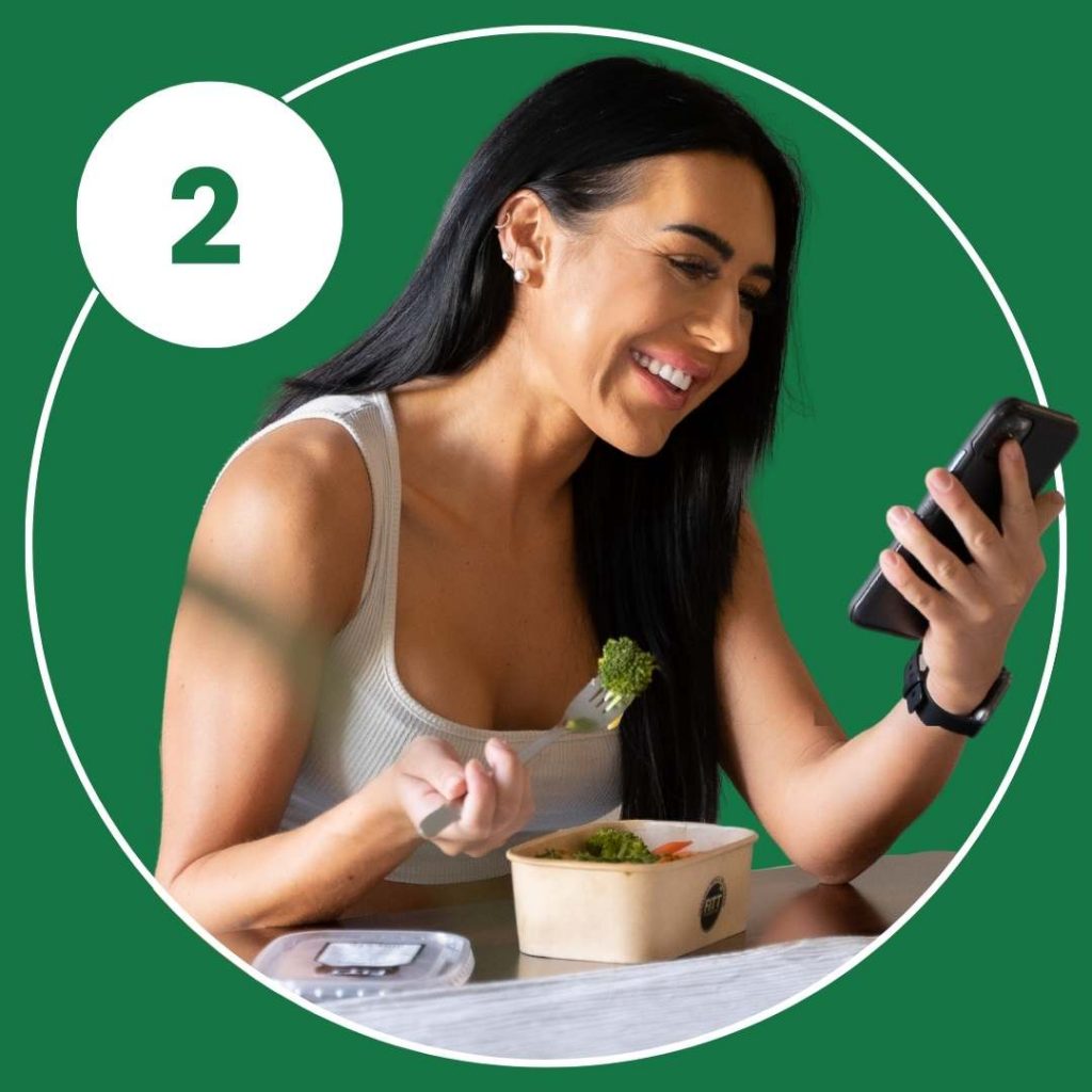 Person using phone while eating healthy meal